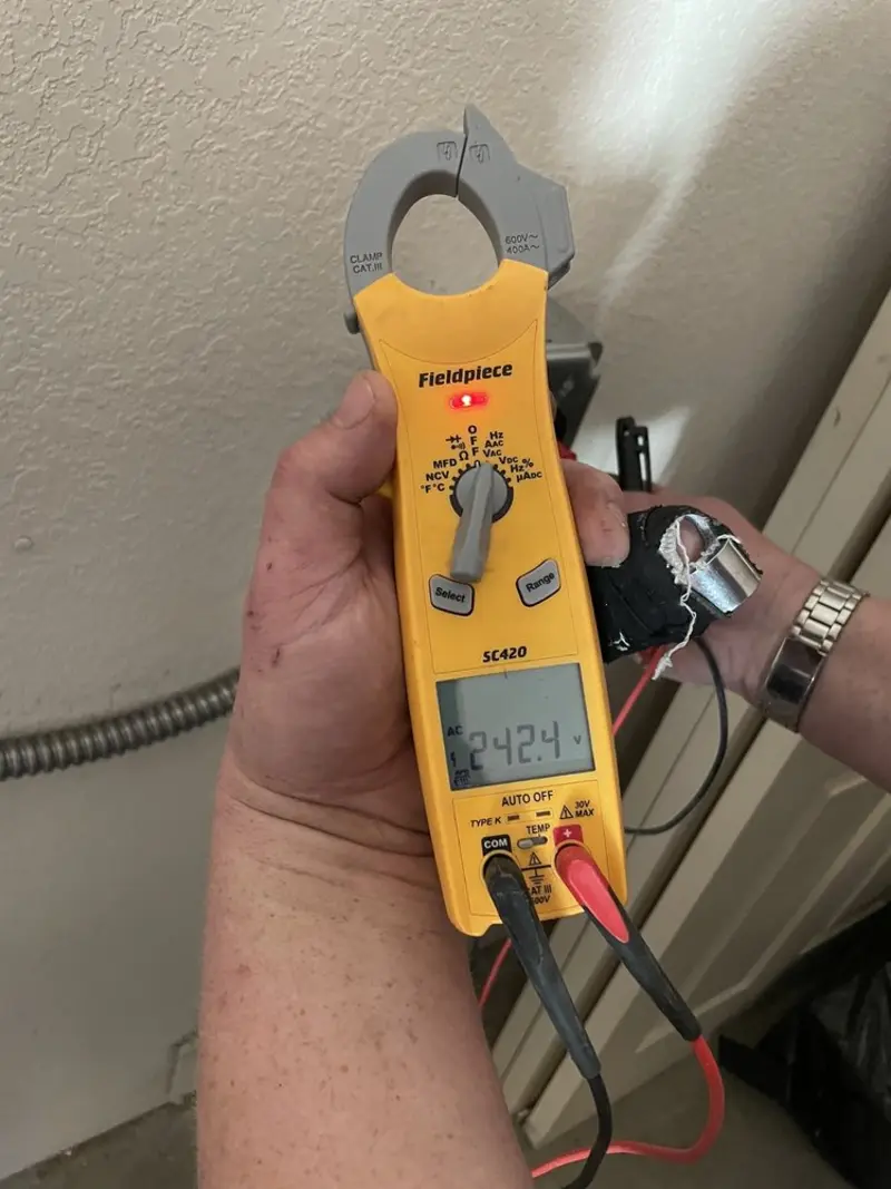 Voltage testing with clamp meter during Electrical Installation Services in Fostoria